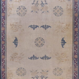 Beige rug featuring scattered blue and tan floral patterns and a detailed maroon and blue border.