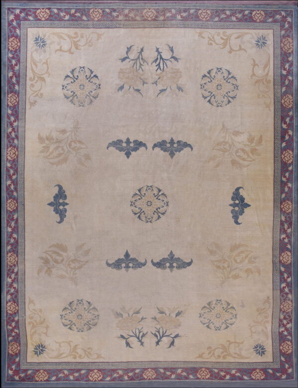 Beige rug featuring scattered blue and tan floral patterns and a detailed maroon and blue border.