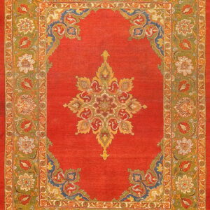 Low-pile rug with a vibrant red field, a central star medallion, and detailed green and orange floral borders.