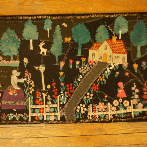 Colorful folk art rug depicting a house, figures, and garden on a dark ground, laid on wood flooring.
