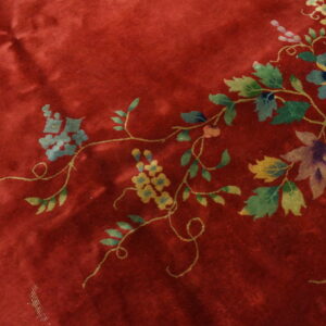 Floral design on red background rug.