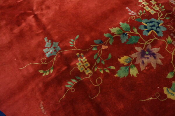 Floral design on red background rug.