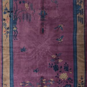 Magenta rug with a blue and tan border and traditional Chinese botanical and insect designs.