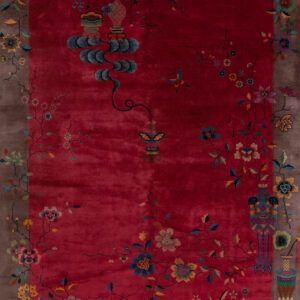 Vibrant red rug with floral patterns.
