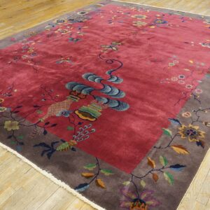 Rose field rug featuring a taupe border and colorful floral patterns rests on distressed wood flooring.