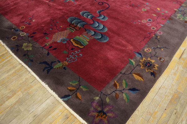 Ornate deep red and brown rug with shimmering high pile and multi-colored flower and vase motifs on wood flooring.