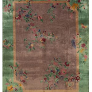 Muted brown center rug with a wide green border and colorful scrolling floral vine pattern.
