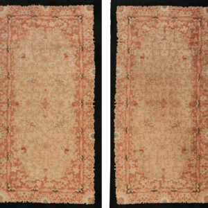 A low-pile rectangular rug displaying dense, traditional floral patterns in beige, rust, and pale blue.