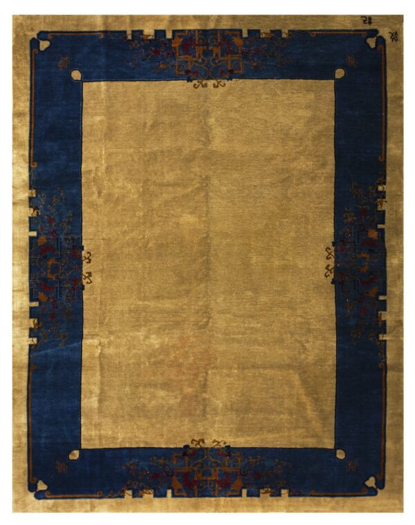 High-luster rug with a plain gold center field and an ornate blue patterned border.