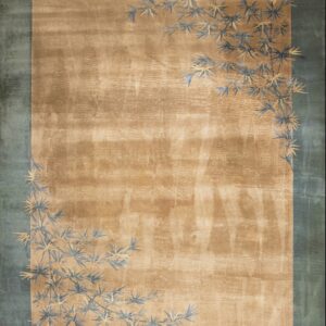 Tan rug with a teal border and stylized blue and gold bamboo leaf pattern near the corners.