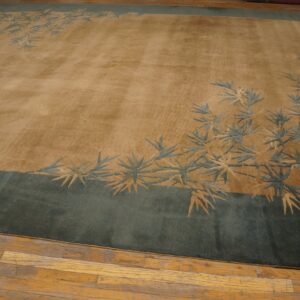 Low-pile tan and green rug featuring a bamboo motif, displayed on worn wooden flooring.