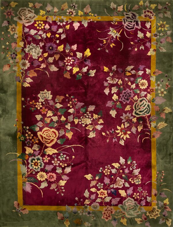 Plush burgundy rug with dense floral vines in many colors and a striking olive green border.