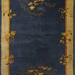 Navy blue rug with gold birds and ducks, framed by a wide khaki border and multicolored floral vines.