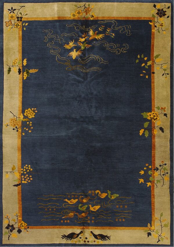 Navy blue rug with gold birds and ducks, framed by a wide khaki border and multicolored floral vines.