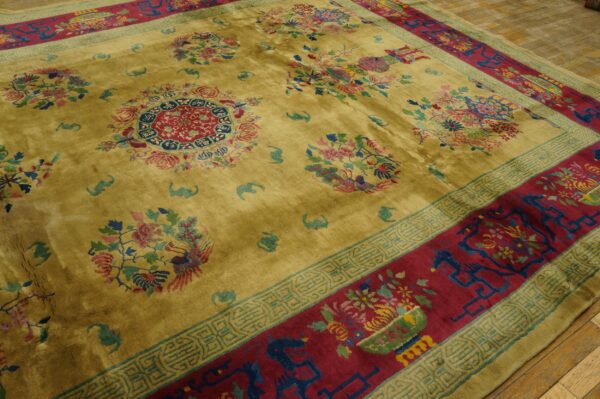 Plush olive-yellow rug displaying multicolor floral medallions and a wide red border with intricate geometric patterns.