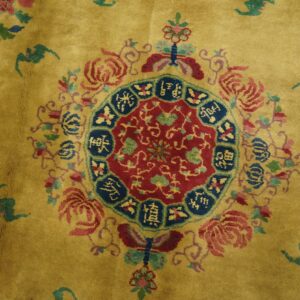 Yellow-gold high-pile rug featuring a vibrant red and blue medallion with surrounding multicolor floral elements.
