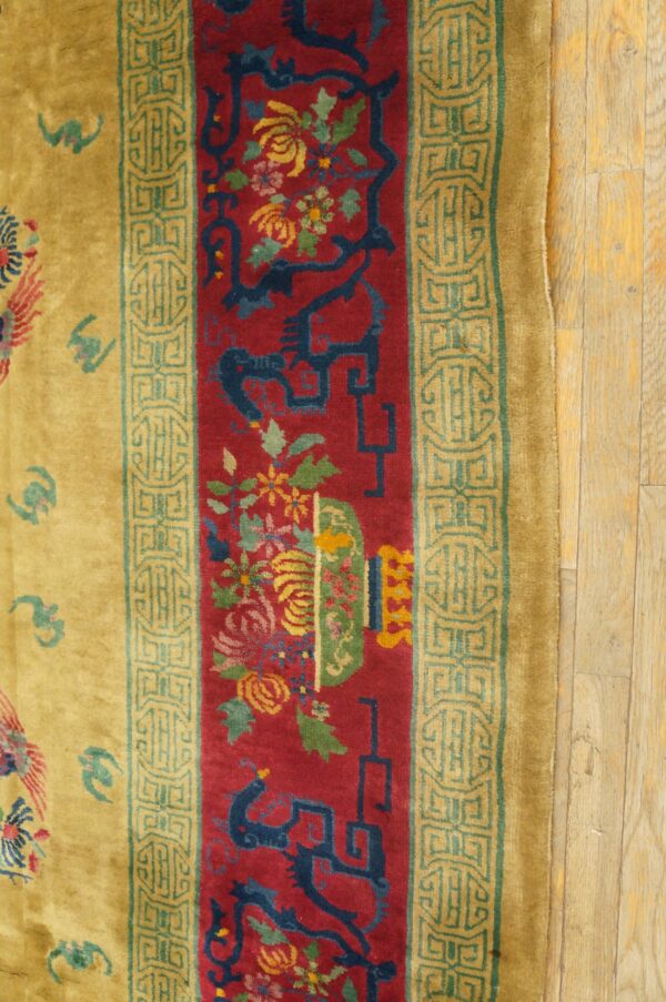 High-pile rug featuring a central red panel with florals, dark blue designs, and golden borders on wood.