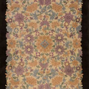 Dense floral rug in purple, gold, and dusty blue on a beige field, framed by a black background.