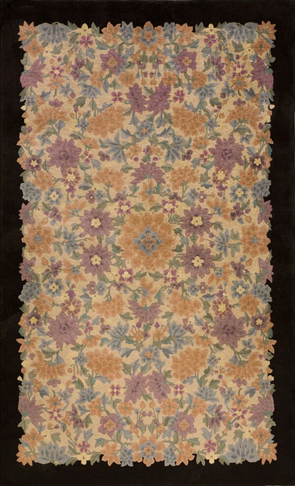 Dense floral rug in purple, gold, and dusty blue on a beige field, framed by a black background.