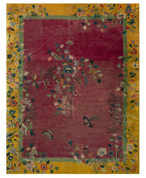Magenta and golden-yellow rug featuring a detailed border of flowering vines, grapes, birds, and butterflies.