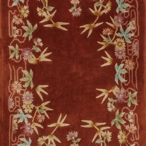 Deep rust rug featuring a plush pile and a border of colorful flowers, leaves, and bamboo shoots.
