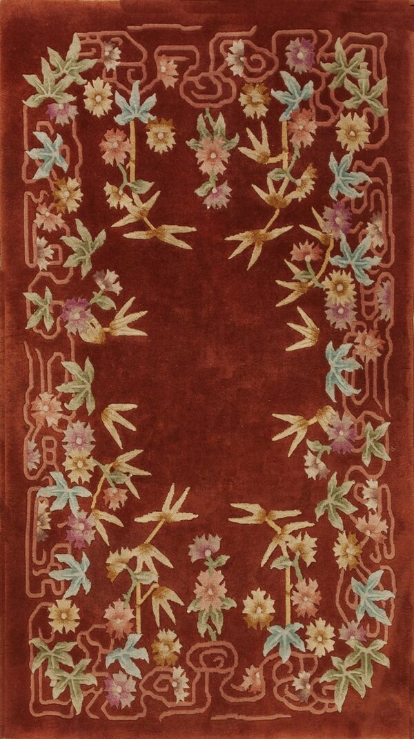 Deep rust rug featuring a plush pile and a border of colorful flowers, leaves, and bamboo shoots.