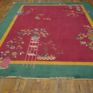 Magenta and teal rug with colorful floral motifs and a yellow stripe border resting on worn wood planks.