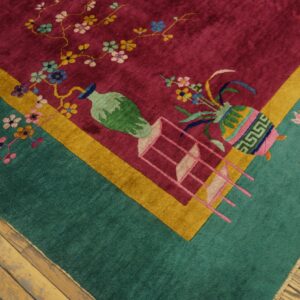 Teal and magenta rug featuring stylized vases, floral branches, and lotus motifs on wood plank floors.