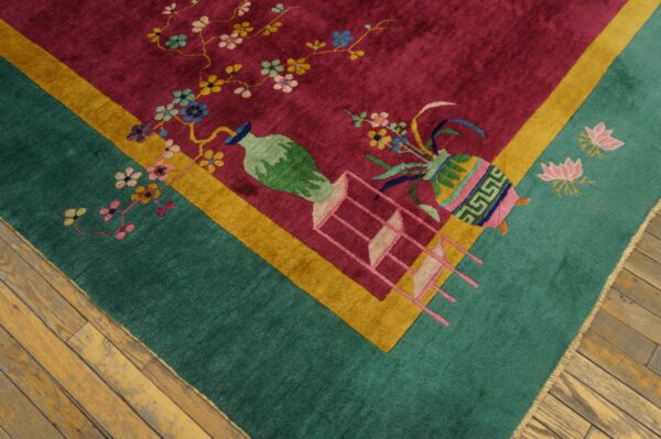 Teal and magenta rug featuring stylized vases, floral branches, and lotus motifs on wood plank floors.