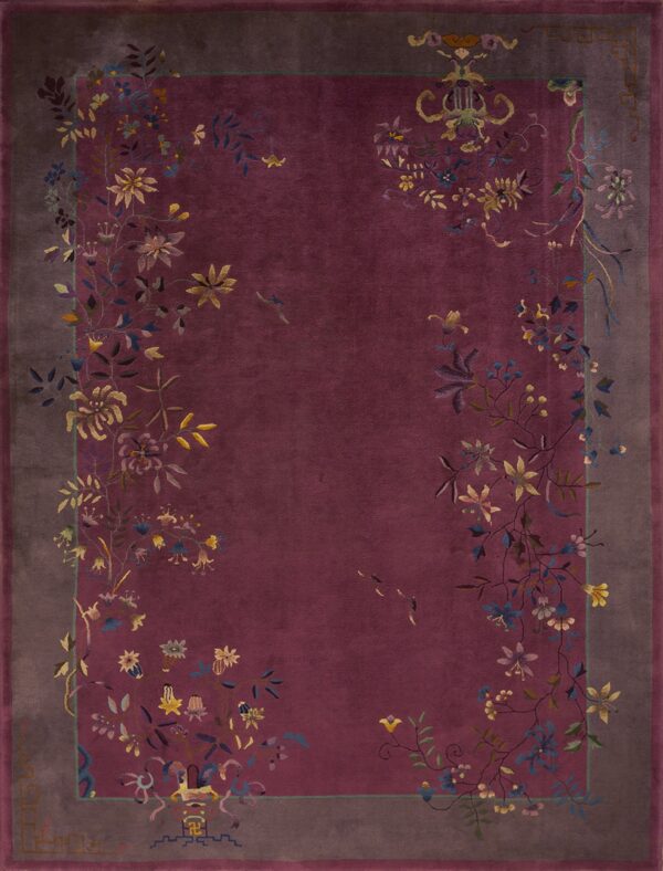 Deep burgundy rug with a gray border and multicolored floral vines trailing across the edges.