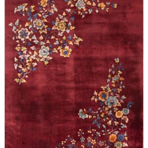 Deep red plush rug featuring multi-colored flower and vine motifs in opposing corners.