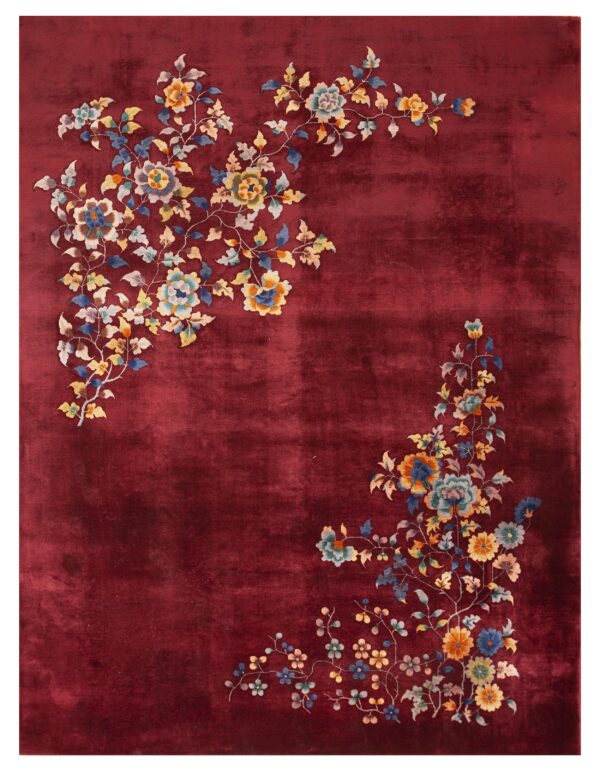 Deep red plush rug featuring multi-colored flower and vine motifs in opposing corners.