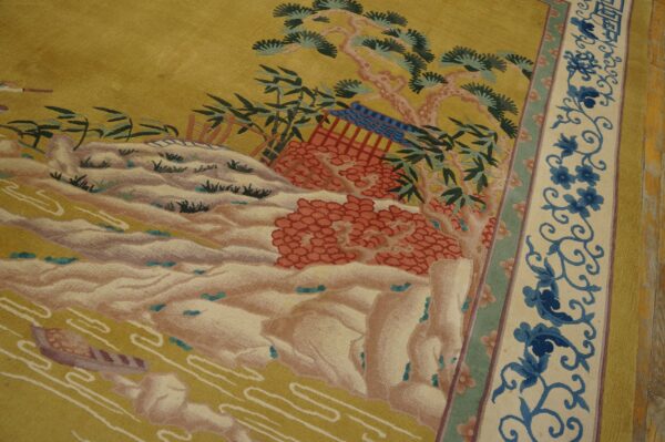 Pictorial rug showing a yellow landscape, terracotta accents, and a wide cream border with blue floral vines.