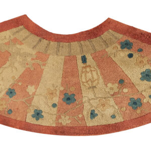 Semi-circular rug with rust and beige radial stripes, detailed with blue and gold floral patterns.