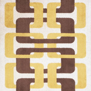 Plush rug featuring an interlocking chain pattern in white, dark brown, and mustard yellow-gold.
