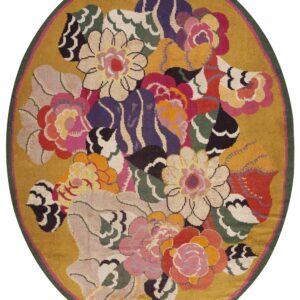 Round rug with a gold background and a colorful floral bouquet pattern bordered by dark green.