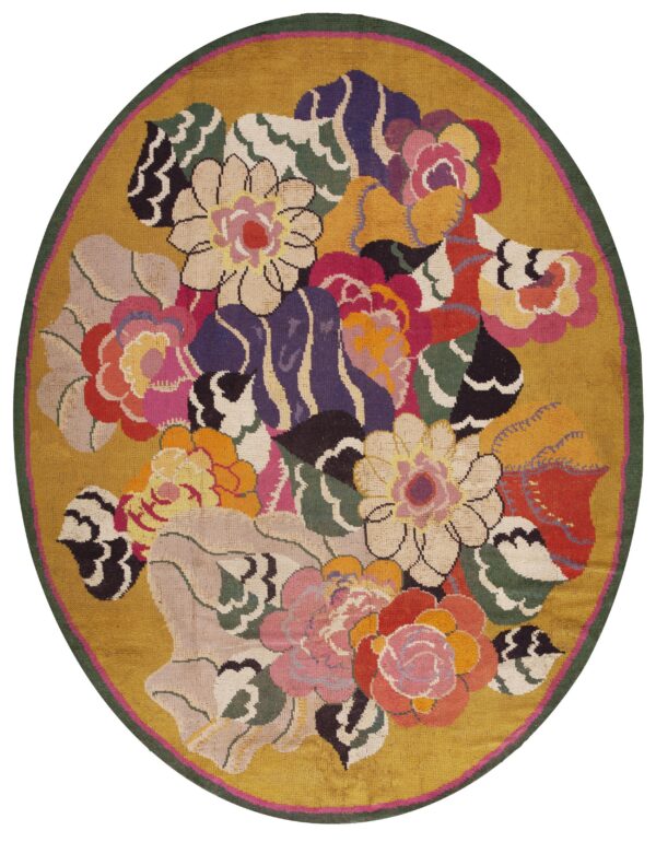 Round rug with a gold background and a colorful floral bouquet pattern bordered by dark green.