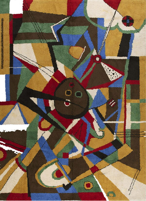 Colorful abstract rug with a dense pile, showing angular blocks of blue, red, gold, green, and brown.