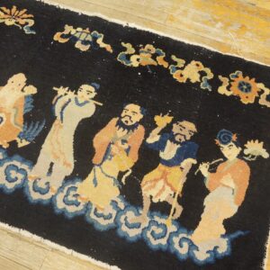 Navy rug with low pile depicts figures in yellow, orange, and blue standing on white clouds on wood planks.