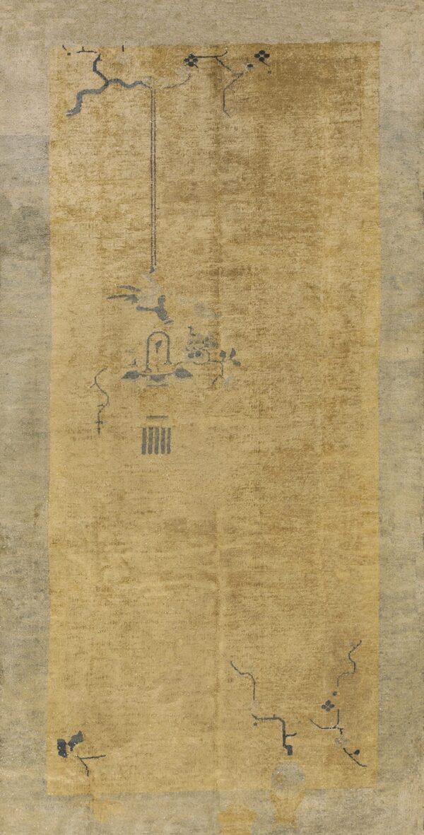 Distressed tan and gray rug featuring a sparse, charcoal linear pattern in the faded center field.