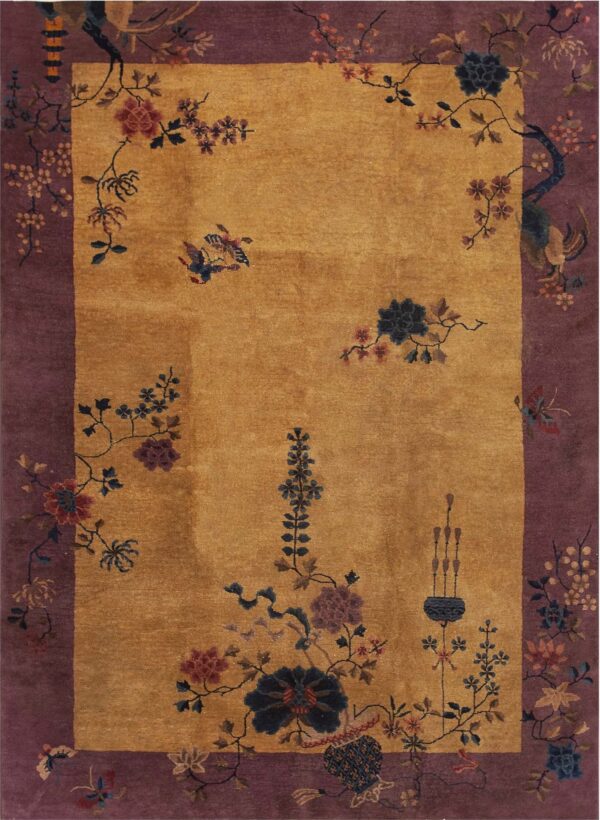 Golden yellow rug with a wide purple border decorated with winding floral branches and birds.
