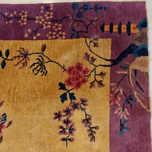 Golden yellow field and deep purple border rug featuring detailed floral and vine motifs on tile.