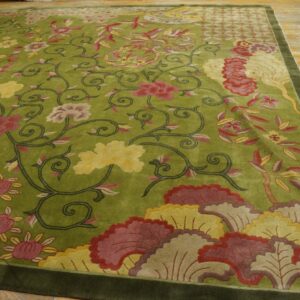 Chartreuse high-pile rug featuring carved floral patterns in red, pink, and yellow rests on worn wood flooring.