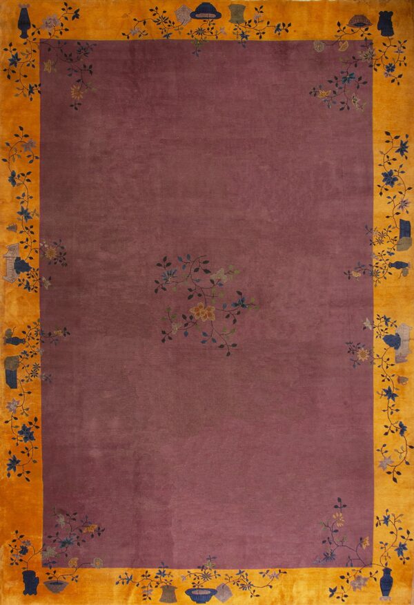 Mauve field rug with a wide yellow-orange border decorated with stylized vases and floral branches.