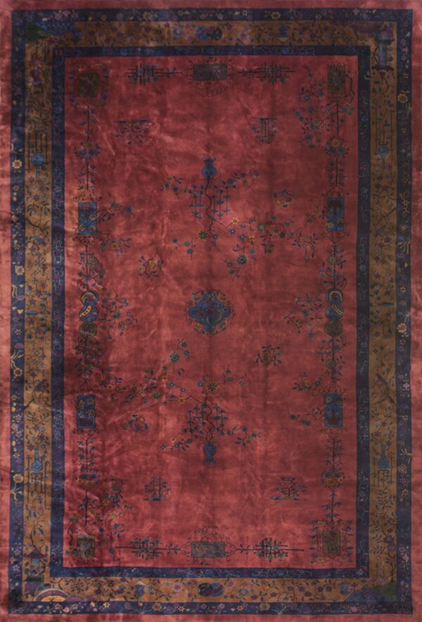 Dusty rose rug with ornate blue, gold, and brown traditional floral medallions and borders.