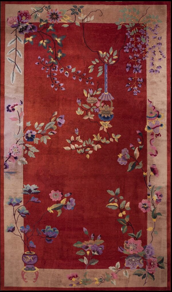Antique art deco large room size wool red rug 1 Plush red rug featuring a large, colorful floral and vine design across the field and wide tan border.