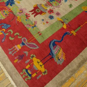 Diagonal view of a tan, red, and green rug featuring a colorful crane motif on rustic wood floors.