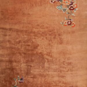 Peach rug with floral embroidery design.