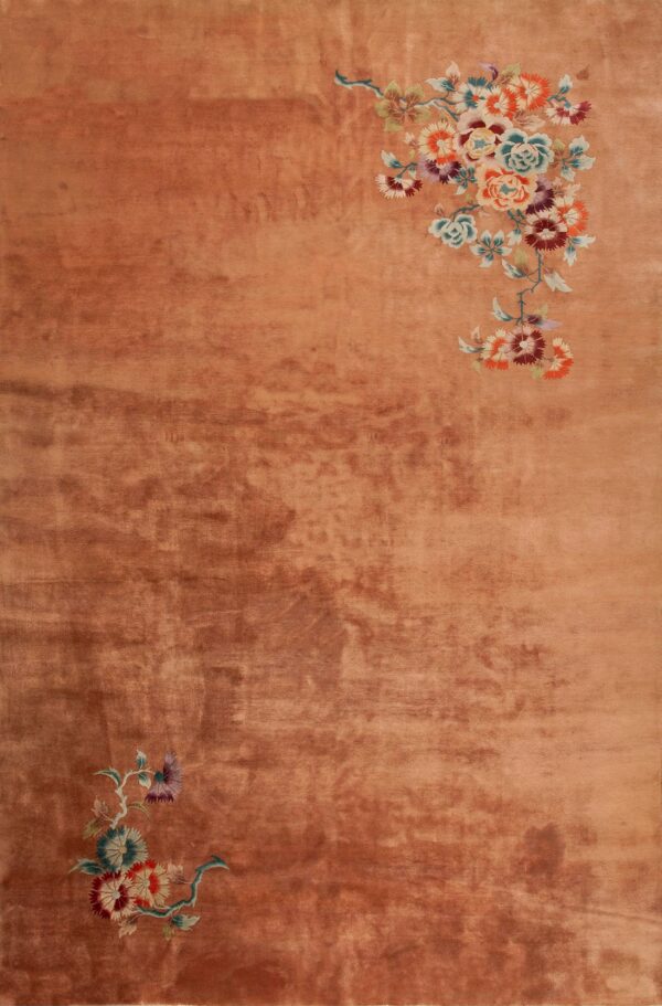 Peach rug with floral embroidery design.