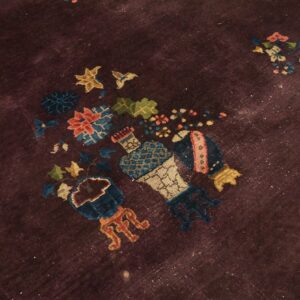 A low-pile rug with a dark purple field and colorful stylized floral vase patterns.